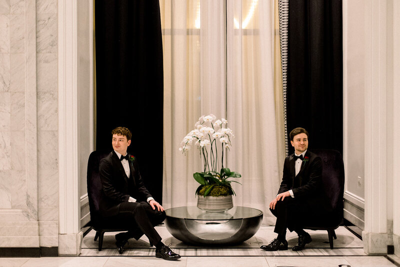 two grooms in a hotel lobby