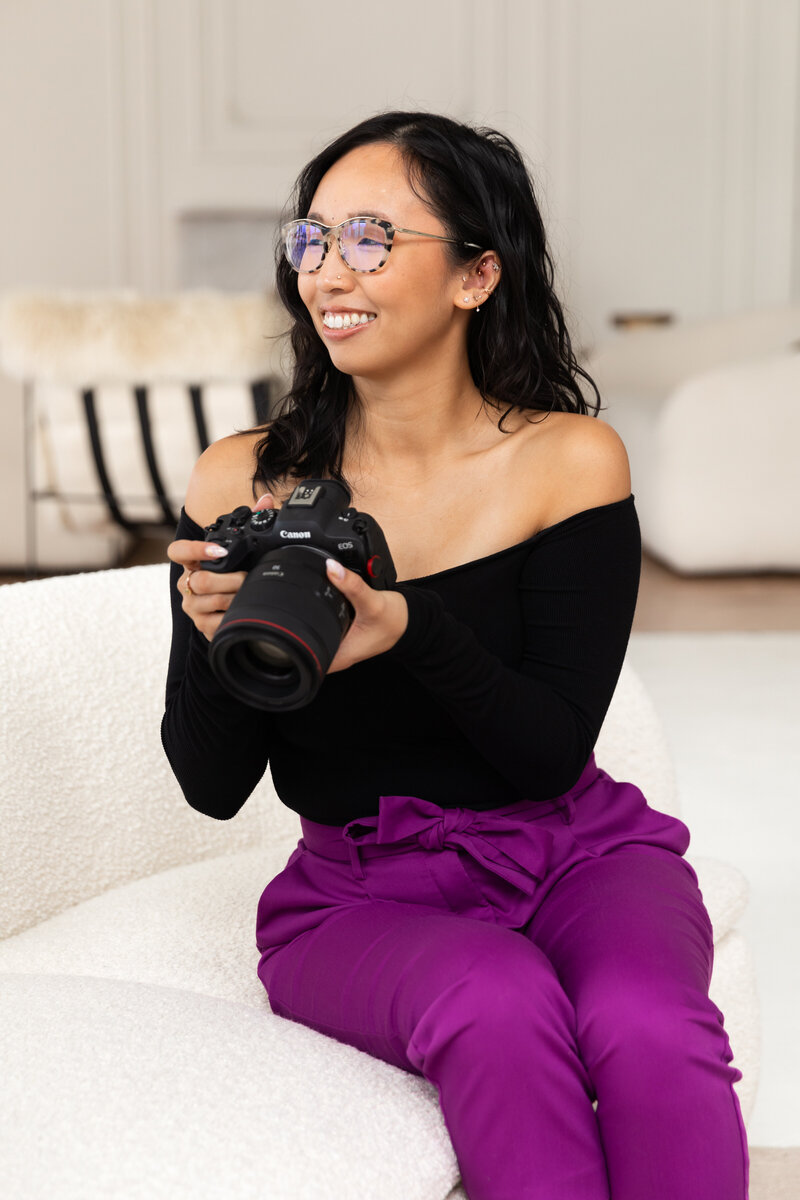 Anh Nguyen, NYC-based photographer, adjusting camera settings.