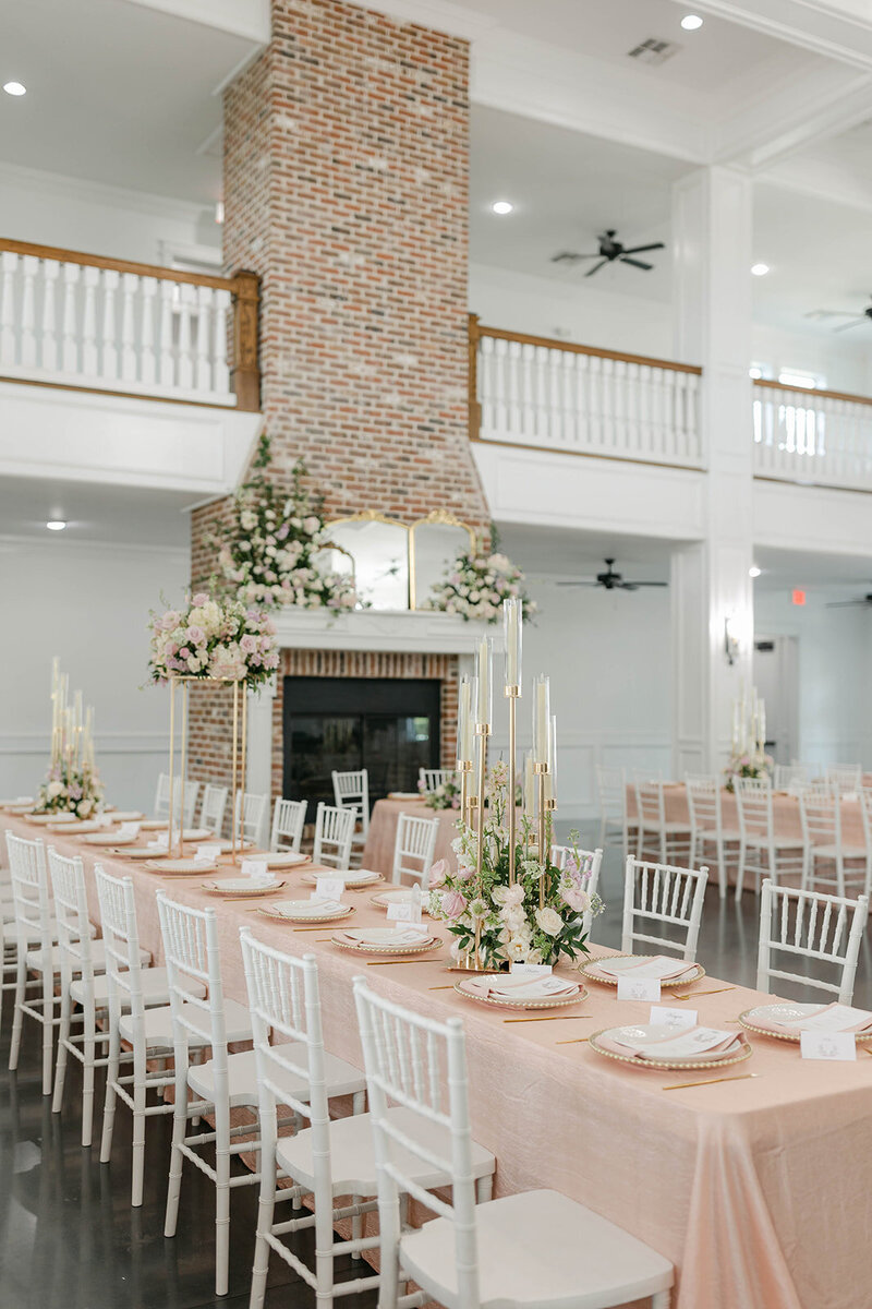 Stylish table setting with elegant linens and floral centerpiece.