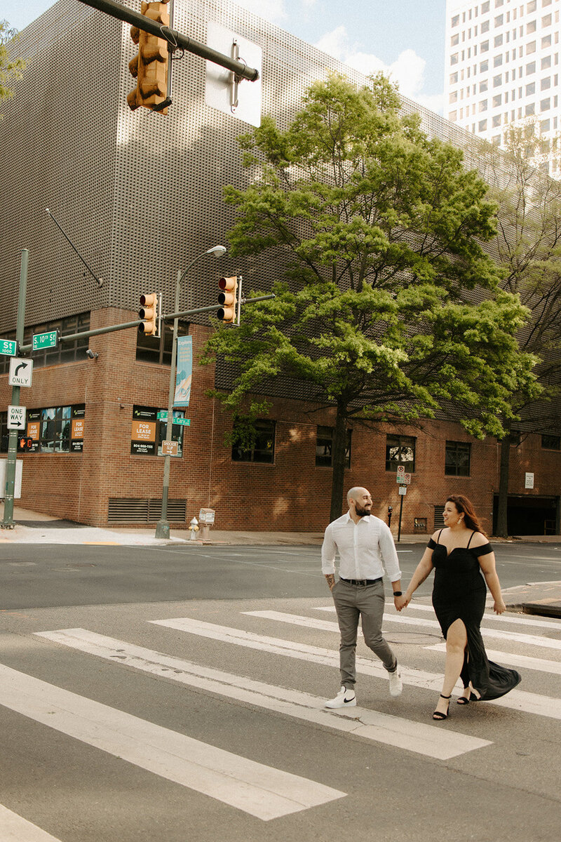 Couple crossing the street during an RVA engagement session 