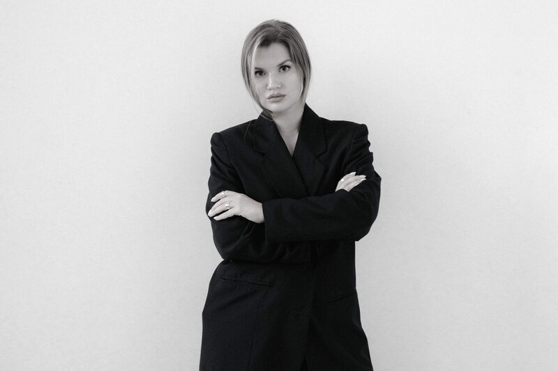 Woman in Black Blazer Standing for Photo
