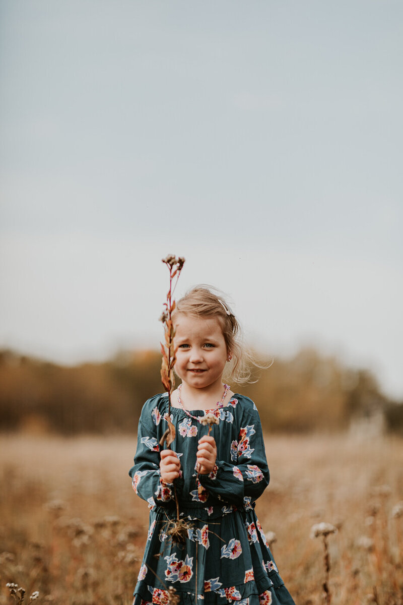 Young child playing with wooden toys, candid family photos at home in Winnipeg 