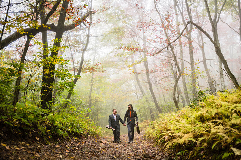 A couple on their elopement day in Roanoke, Virginia have their first dance along the shores of Carvin's Cove.