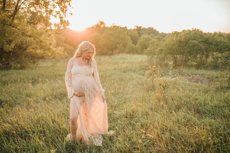 maternity session in a field at sunset