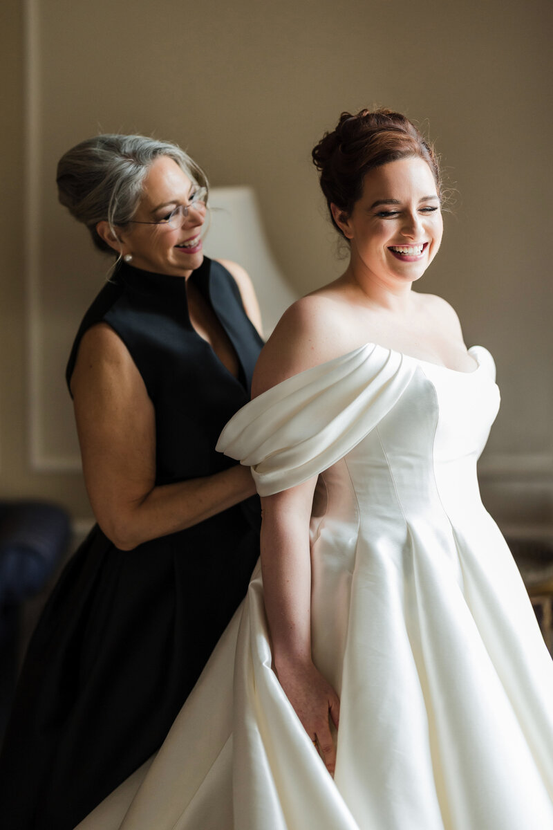 A beautiful bride getting ready with her mother on her wedding at Hotel DuPont in Delaware.