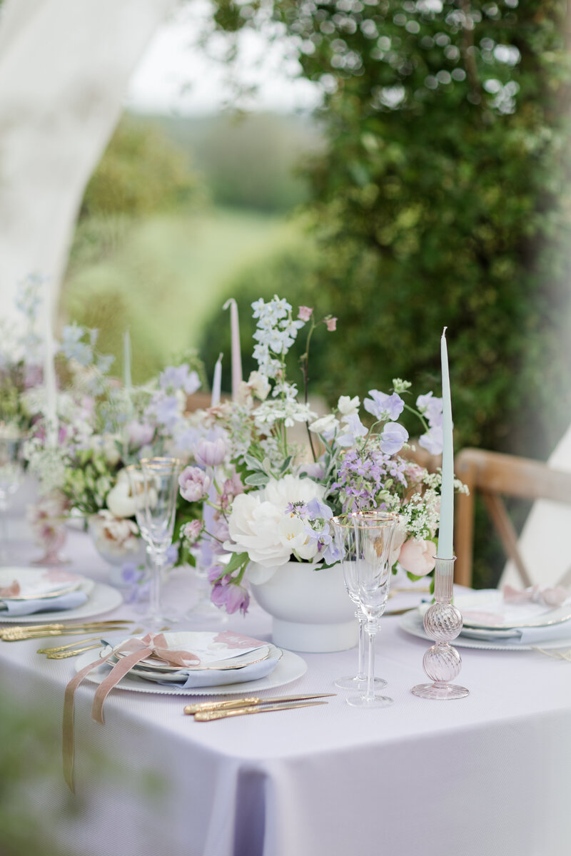 whimsical wedding tablescape in soft pastels with purple linen and gold cutlery photographed by Adorlee weddings