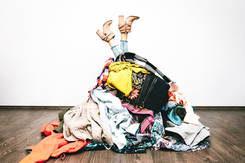 woman upside with laundry covering her