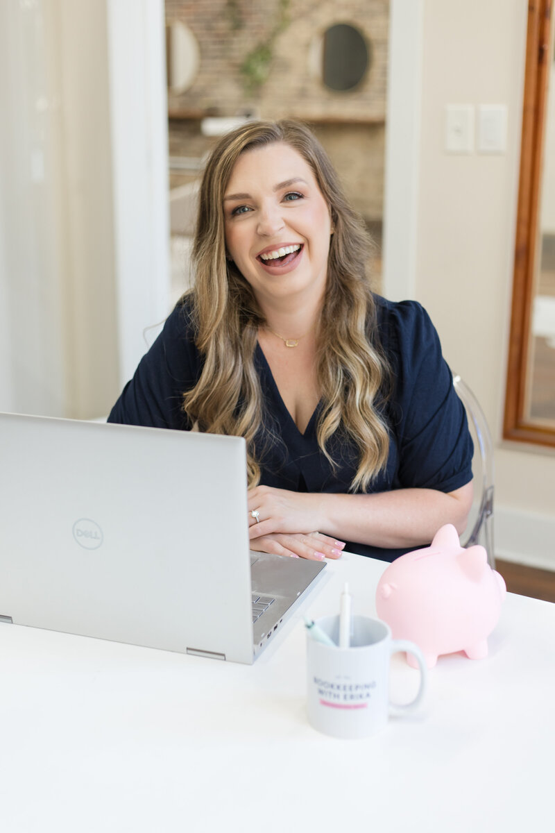 Erika smiling in sitting at her desk in her office