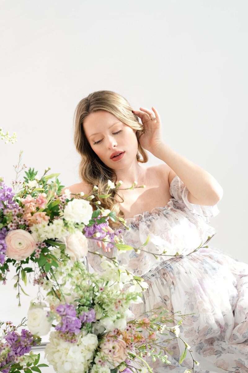 In-studio Maternity Session with floor floral arrangments for mother's day minis photoshoot