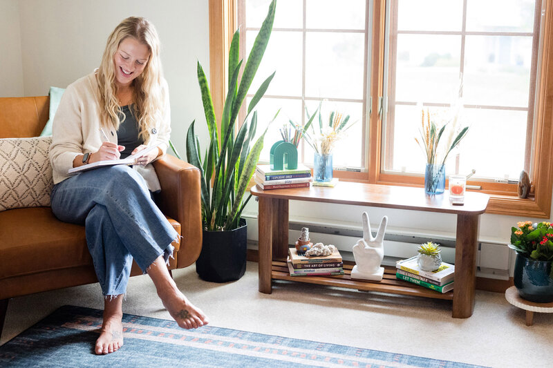Amy Fink sitting on a chair in her home office