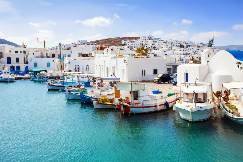 Azure waters and colorful boats docked in Paros Greece
