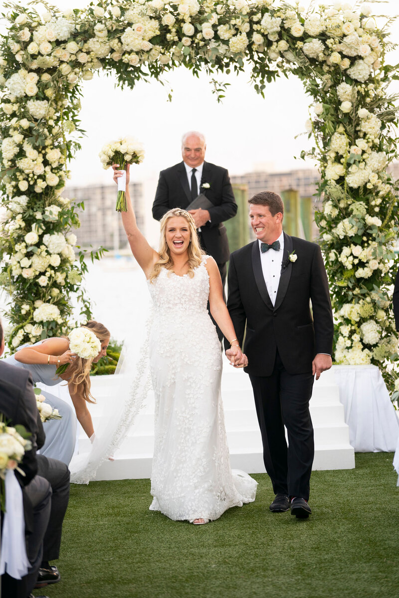 Newlywed couple joyfully walking down the aisle at their Fort Lauderdale wedding.