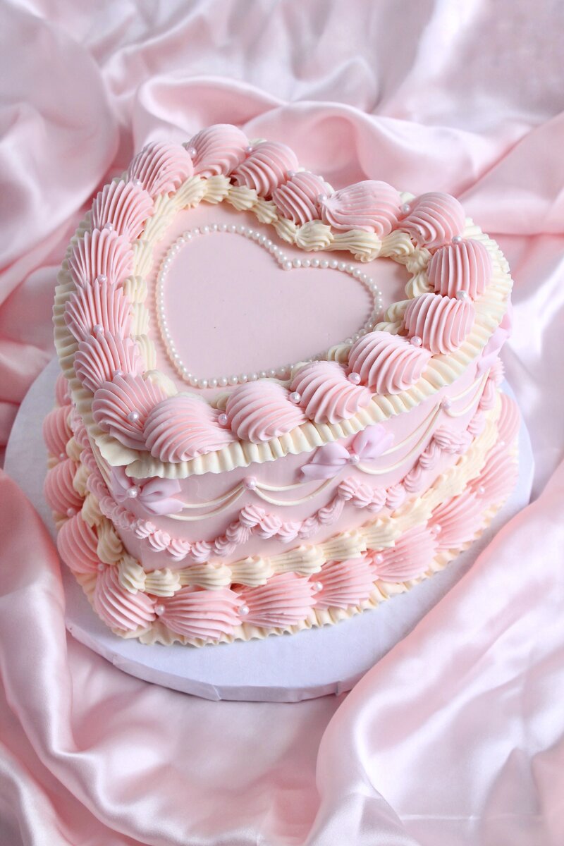 Pink cake with frosting and gold butterflies