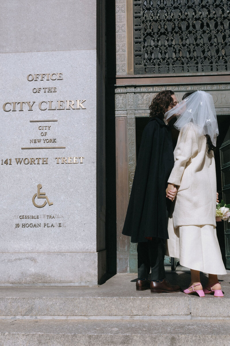 Couple standing together outside Manhattan City Hall during their NYC elopement