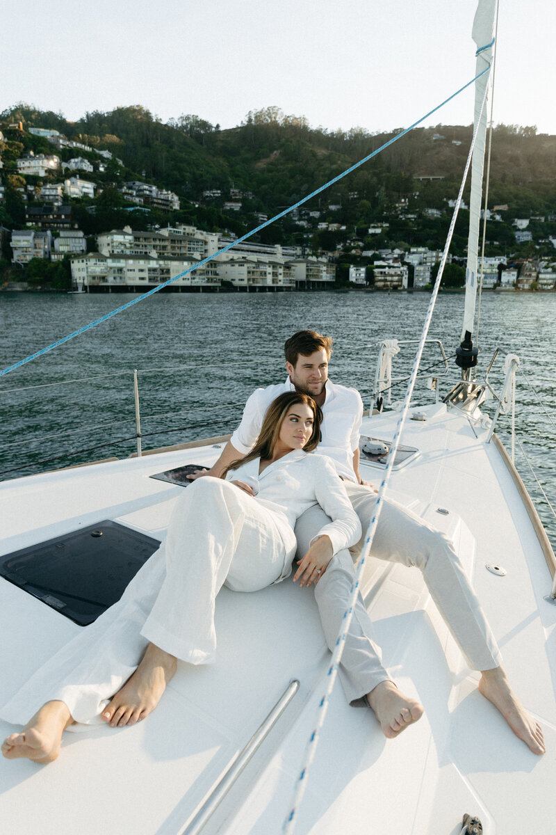 couple on a sailboat relaxing
