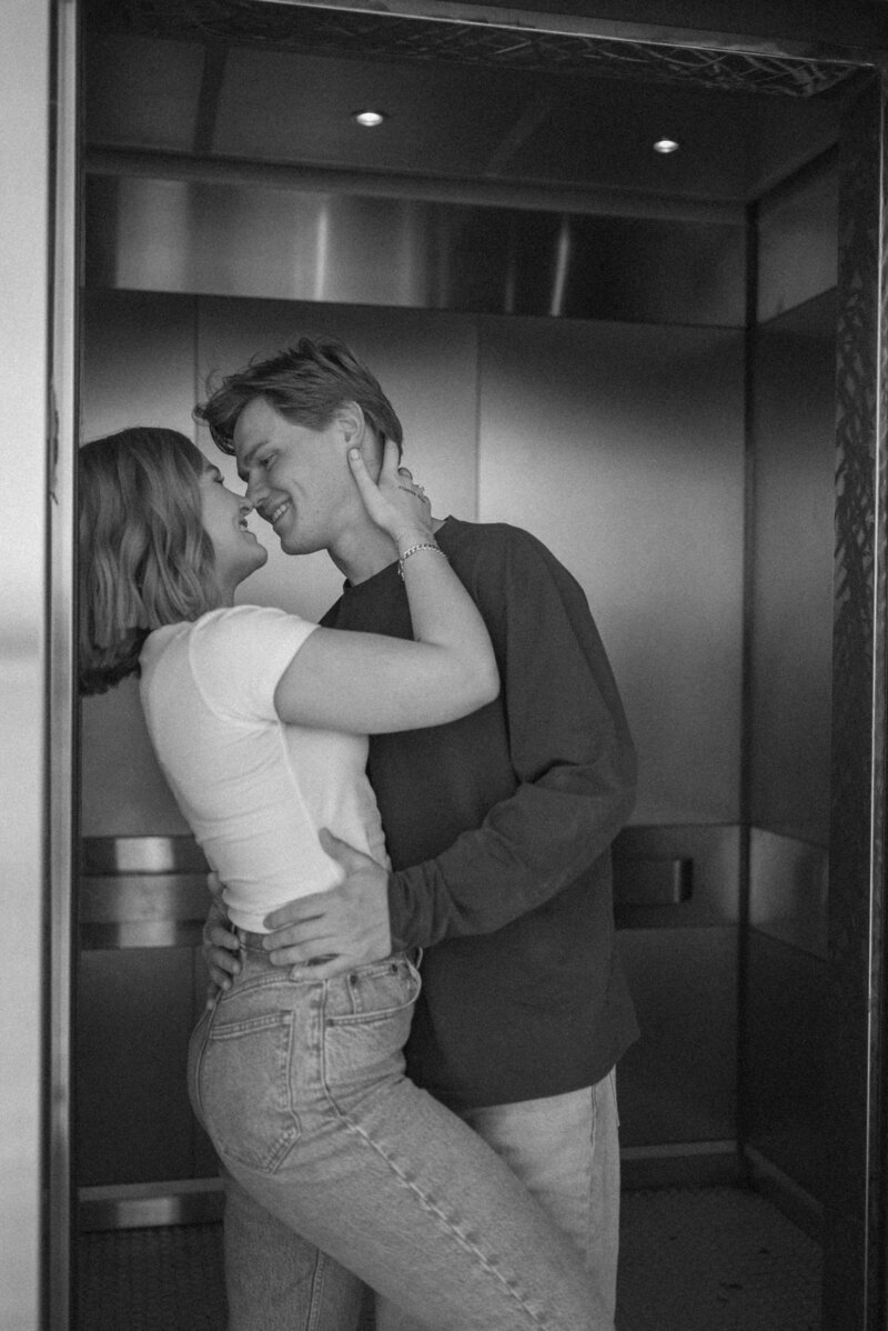 couples embracing and touching noses at the entrance of an elevator