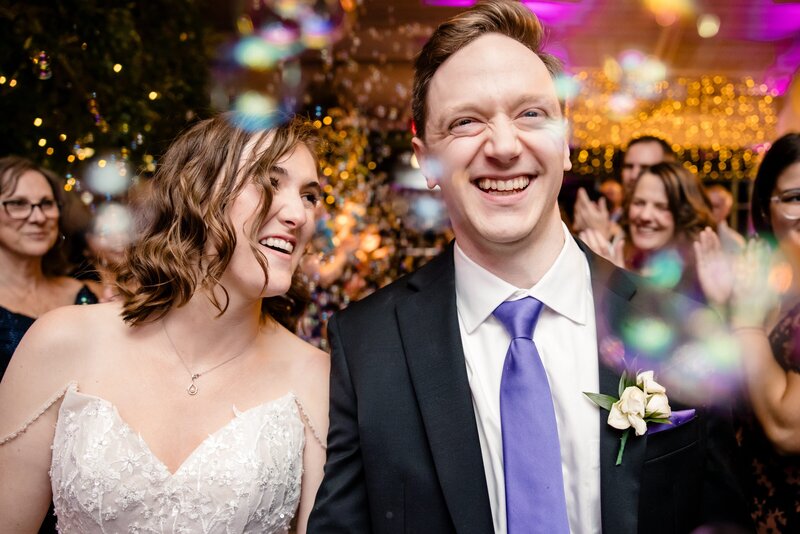 a bride and groom leave their wedding reception