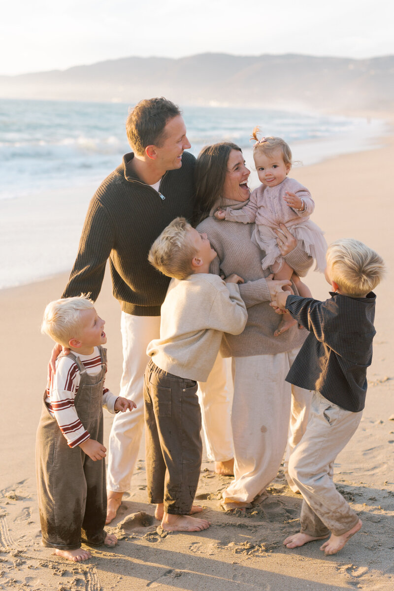 Candid family photo on Westward beach at sunset by Malibu photographer