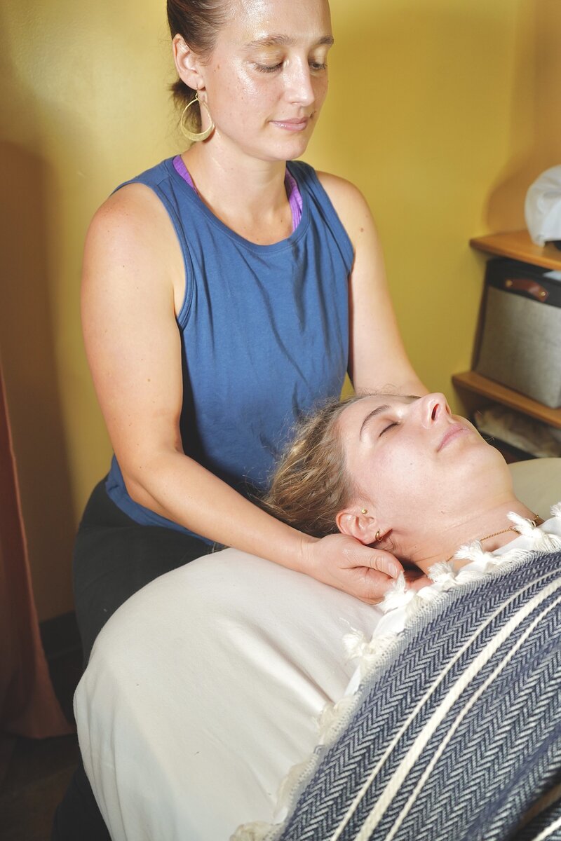 woman massaging neck of client