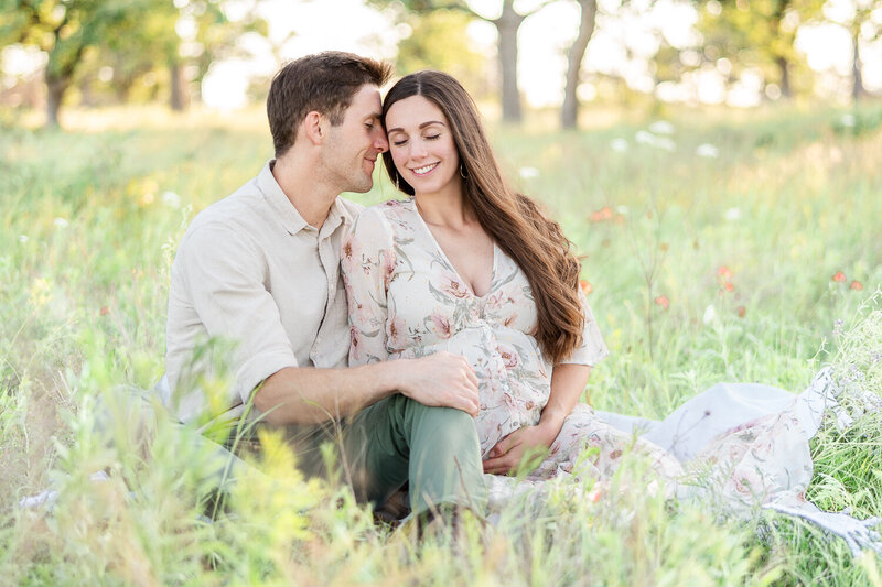 couple in a flower field for maternity session