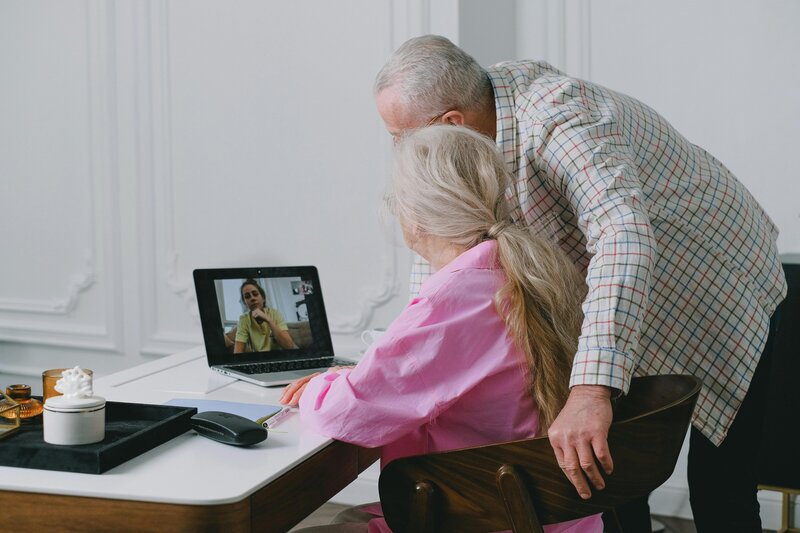 Older couple on video call with therapist