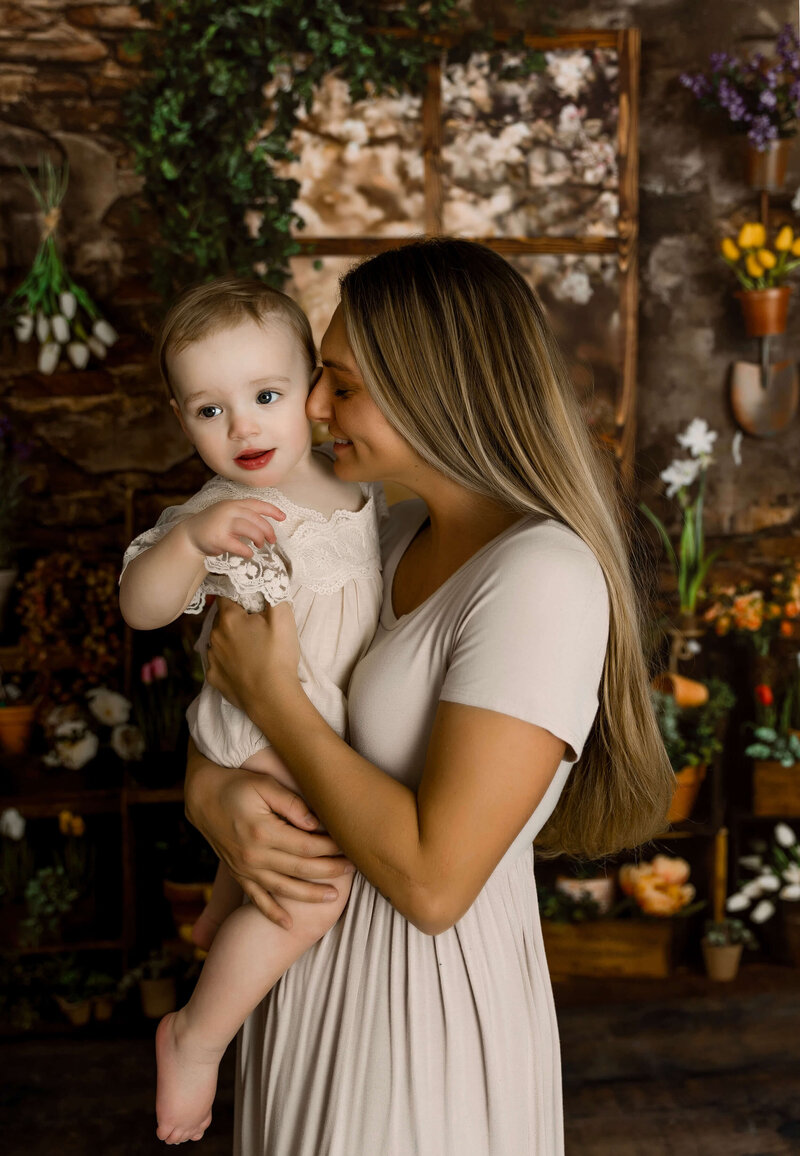 Photo of a mom and baby girl snuggling in an Erie Pa photography studio