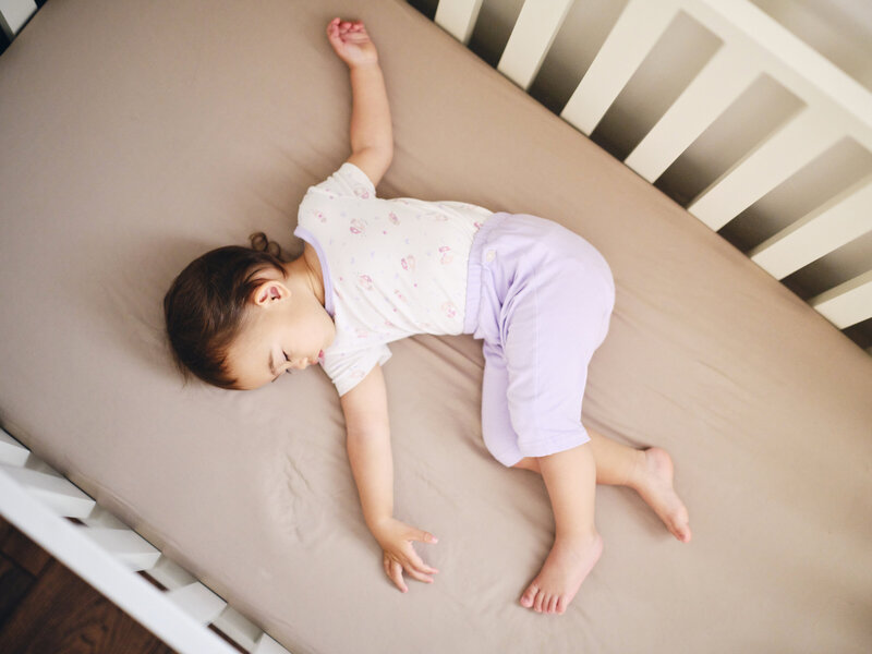 Toddler sleeping in crib