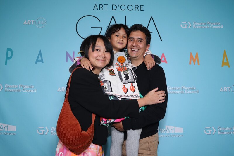 A family of three poses together with big smiles at the Art d’Core Gala in Phoenix—photographed by MISGIF’s experienced corporate event photographers.