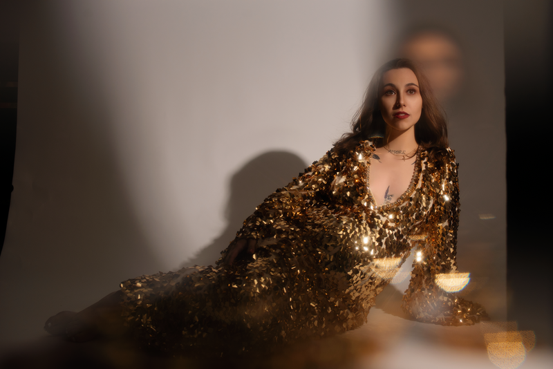 Maryland Maternity Photography - Mom laying down with split light in gold sparkle maternity gown 2