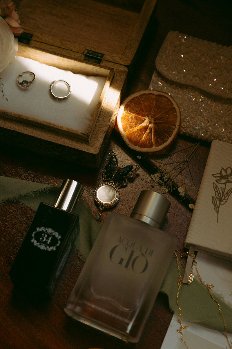 A couple sits on the edge of a wall laughing and enjoying eachother's company