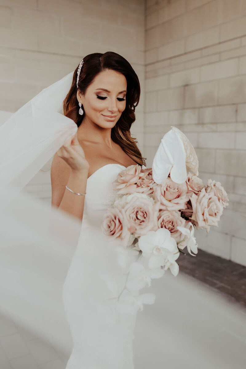 Bride in white with modern rose bouquet