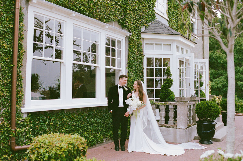 Wedding Couple on a Spanish street surrounded by bougainvill