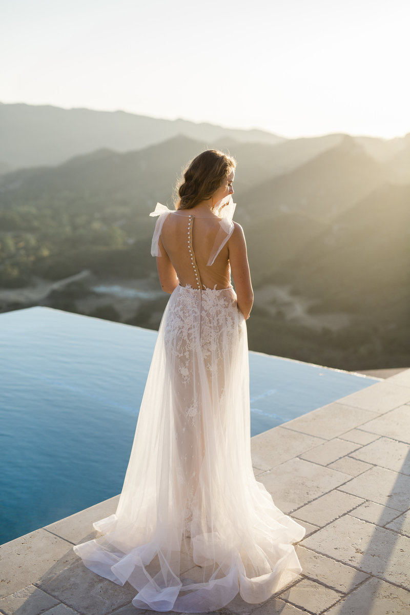 Bride with couture dress poses for wedding photographer My Sun and Stars Co at Malibu Rocky Oaks Estate
