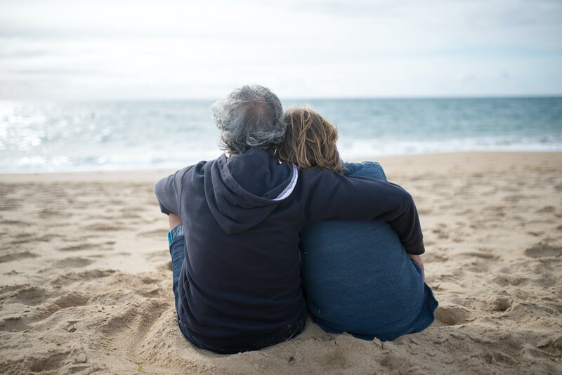 Stock photo of a retired couple on the beach after selling their home.