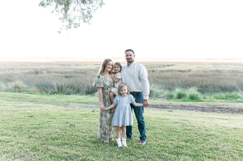 family smiling together taken by family photographers in savannah ga

