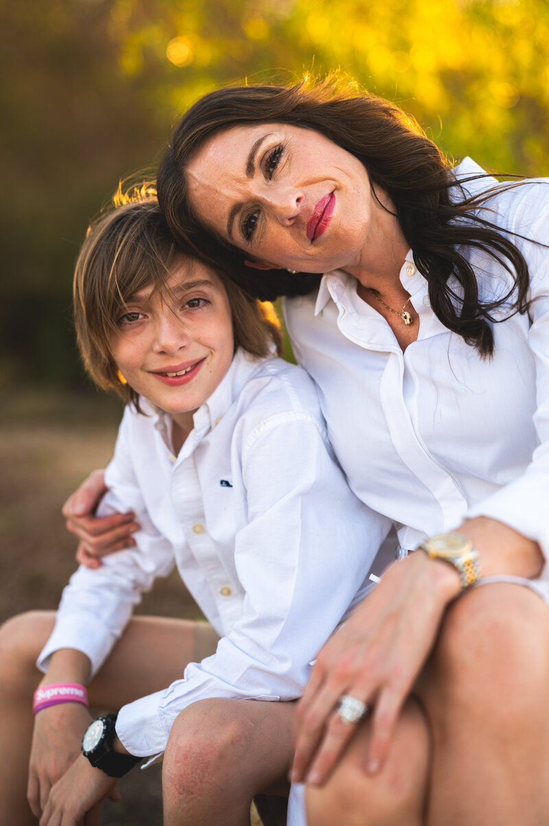 Mother and son embracing outdoors in soft evening light — heartfelt family photography in Aledo by Poppy + Blue Photography