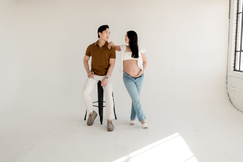 Pregnant woman and husband posing together