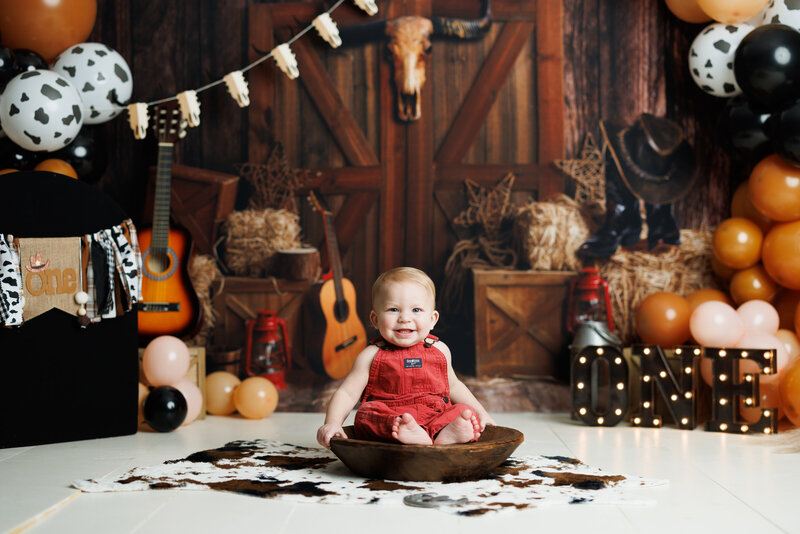 Toddler having a messy and fun “steak smash” birthday session in Canton, Georgia, captured by Victoria Lee Photography.