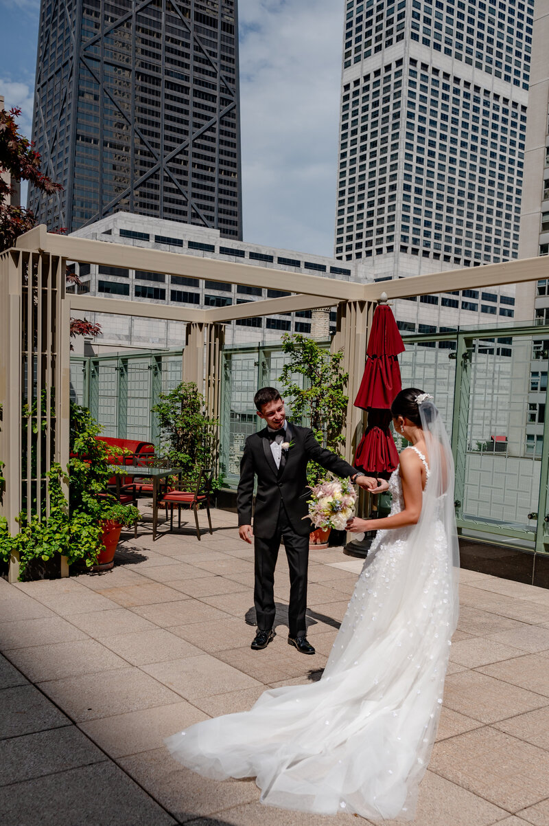 Bride and groom stand on the patio at The Peninsula Hotel in Chicago