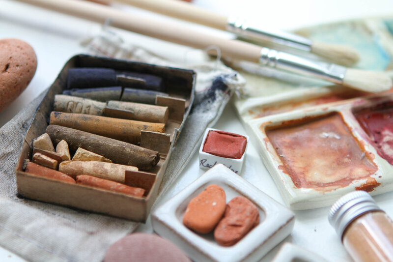 Natural pigments in earthy tones made by grinding rocks into fine powder for handmade paint