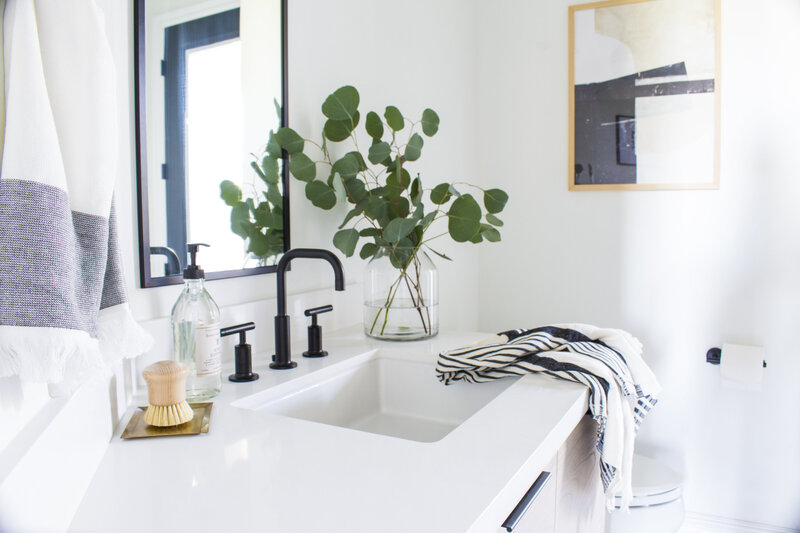 White Bathroom Counter with Black Modern Fixtures