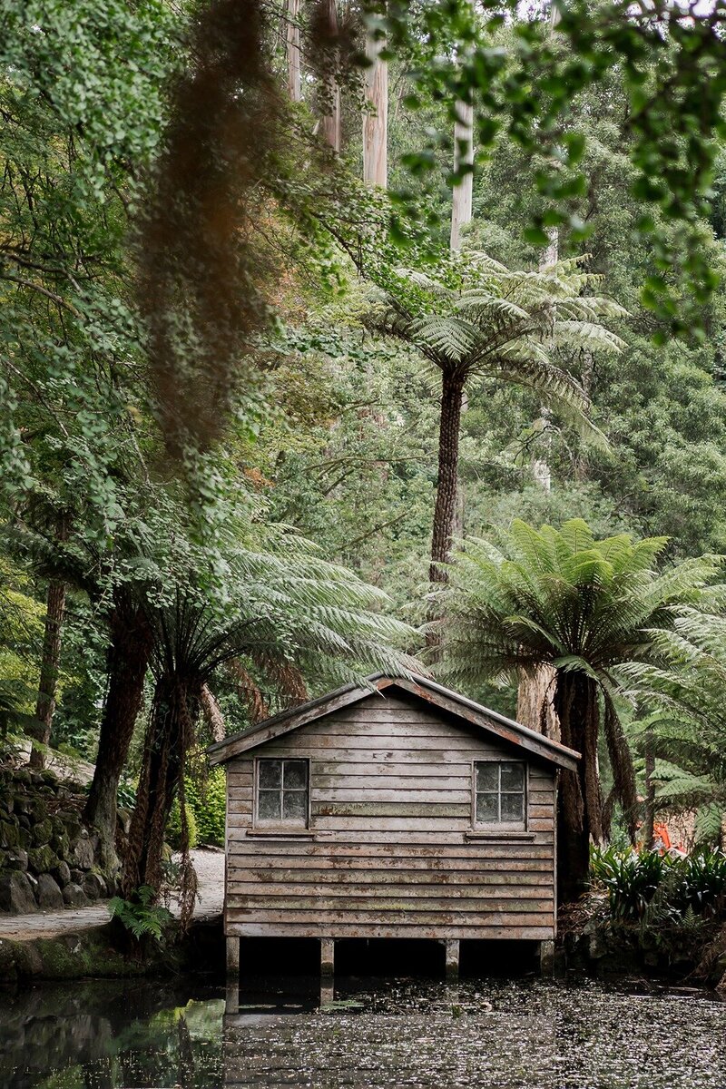 A smiling bride and groom walking through the outdoor area of a restaurant