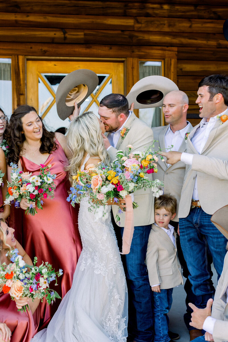 texas couple and bridal party holding colorful wedding bouquets