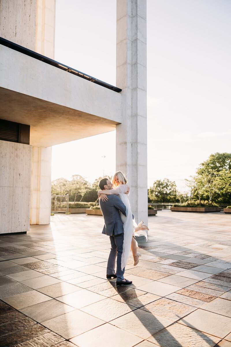 Couple spinning together on the 
balcony of the National Library in Canberra ACT. Photo by Acacia & Grace Photography
