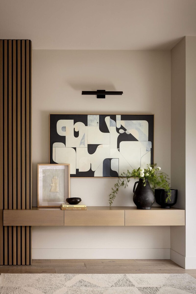 Warm Japandi entryway with a minimalist console table, bold area rug, and fresh florals to create a calm first impression.