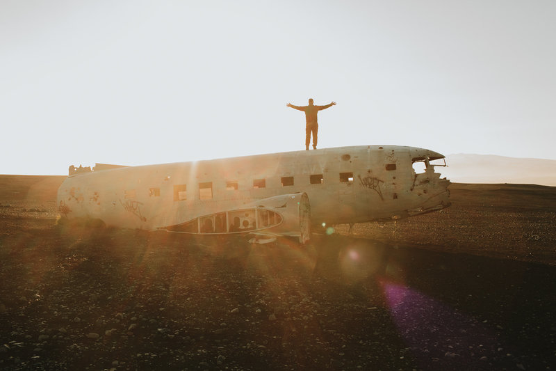 Tony Asgari standing on top of a crashed airplane.