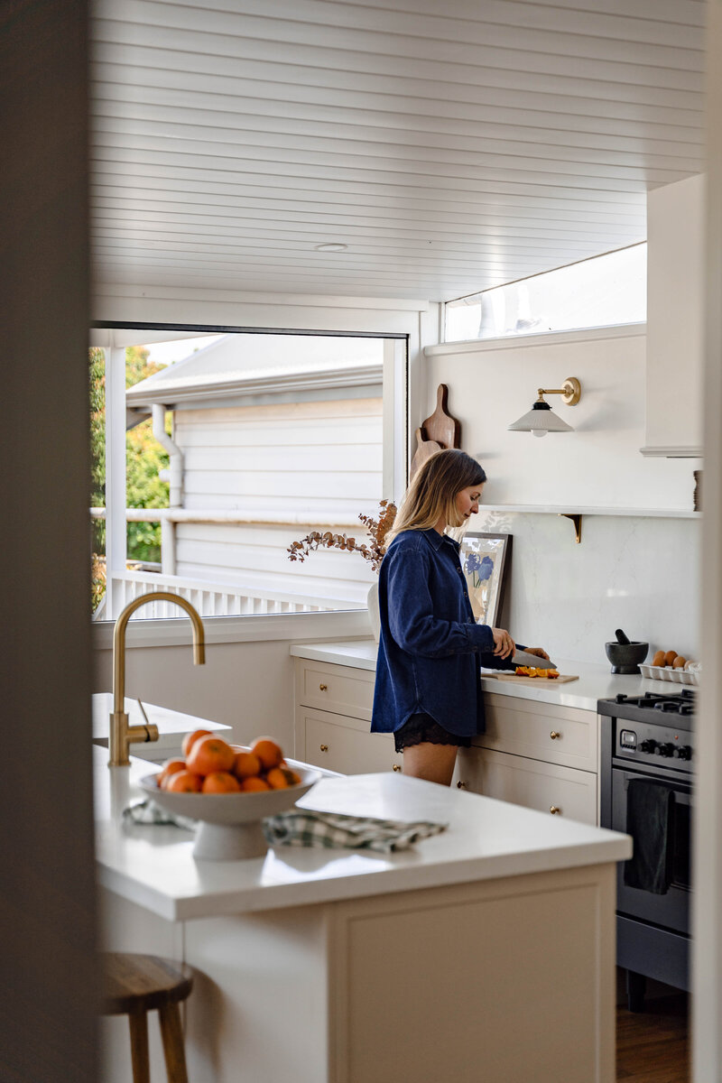 jesse-mccabe-renovation-kitchen-woman-cutting-corner-mayfield-nsw