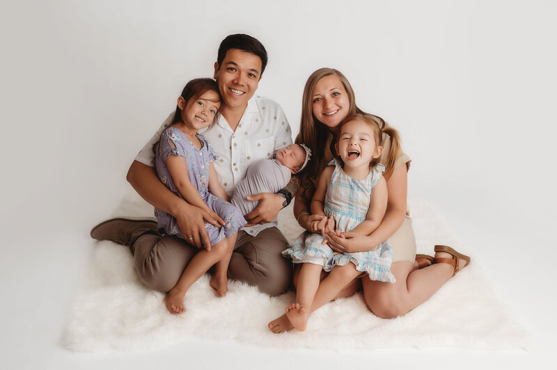 Family Poses with their Infant during Newborn Photoshoot in Asheville, NC.