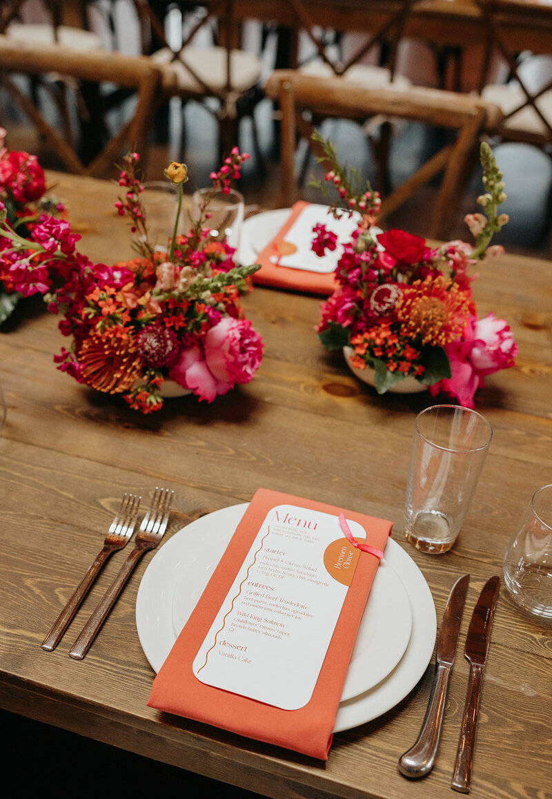 Reception tablescape with peonies, roses, and candleligh