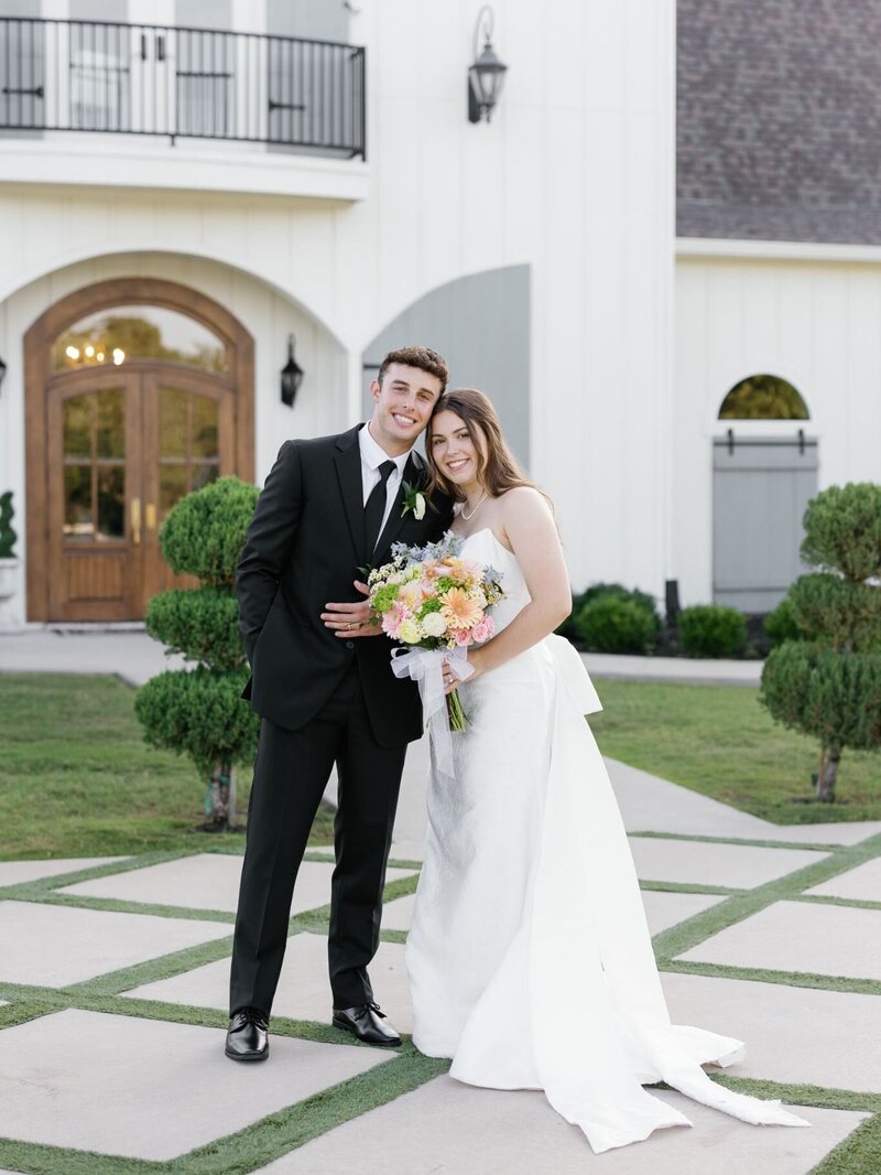Bride and groom hand in hand outside a timeless wedding venue captured by Reilly Erin Photography.